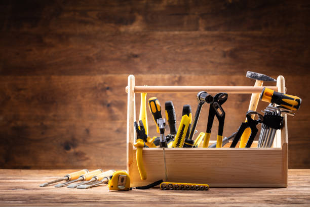 Toolbox with maintenance tools on a wooden workbench